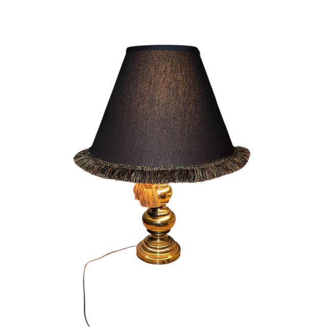 An exquisite mid-century solid brass table lamp by the renowned Stiffel Lamp Company. This piece features a classic...