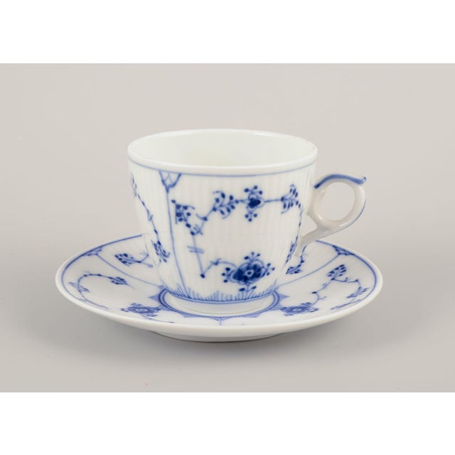 Royal copenhagen blue fluted plain. A set of four coffee cups with saucers in porcelain. Model number 1/80 dated:...
