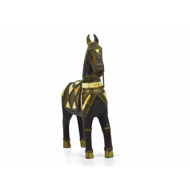 This striking Anglo-Indian figurine captures the regal essence of a decorated stallion, expertly handcrafted from deep-...