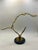 Striking mid-century modern brass sculpture featuring three seagulls in flight mounted on a polished black marble base....