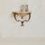 A petite French brass and marble wall-mounted console, dating to the 1940s. Shaped in scrolling wrought brass, the frame...