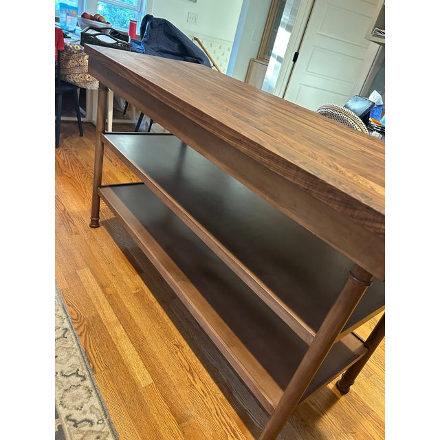 Beautiful English - style kitchen island with two open shelves, turned wood legs and a butcher block top. Hand crafted by...