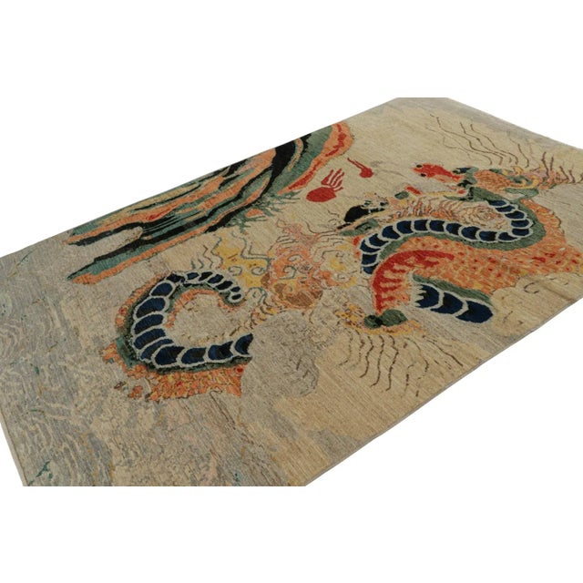 Hand-knotted in wool, this 6x9 modern rug, originating from Afghanistan, features a beige/brown field with an illustration...