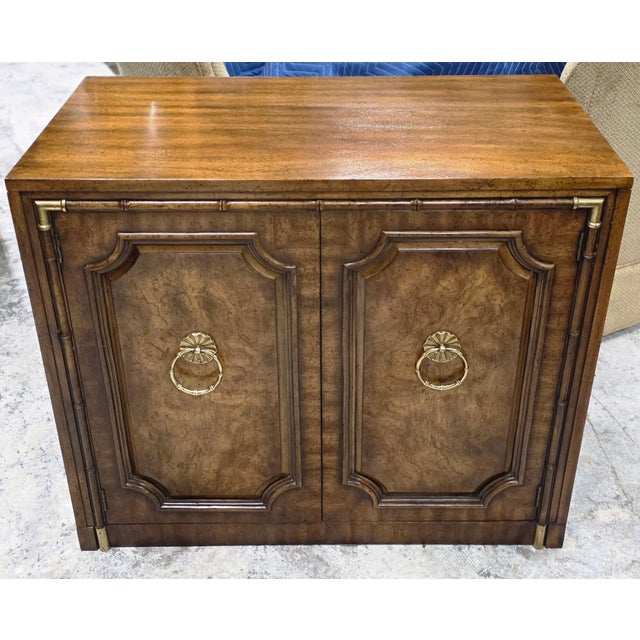 This Mid-Century Weiman Faux Bamboo Burl Server Cabinet is a beautiful piece with a stately visual profile, architectural...