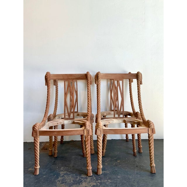 This extraordinary set of four dining chair frames is a masterful showcase of Hollywood Regency whimsicality and artisanal...