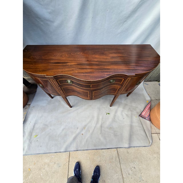 This is an exceptionally beautiful mahogany sideboard in the style of George III. There is beautiful inlay work. It...