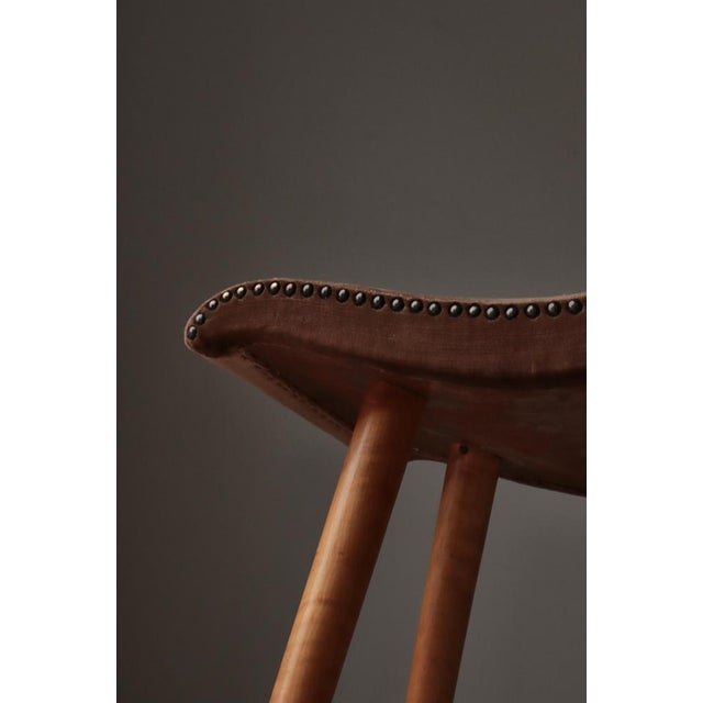 Elegant Swedish Modern stool from the 1940s, crafted in solid birchwood with beautifully turned legs and a sculptural,...
