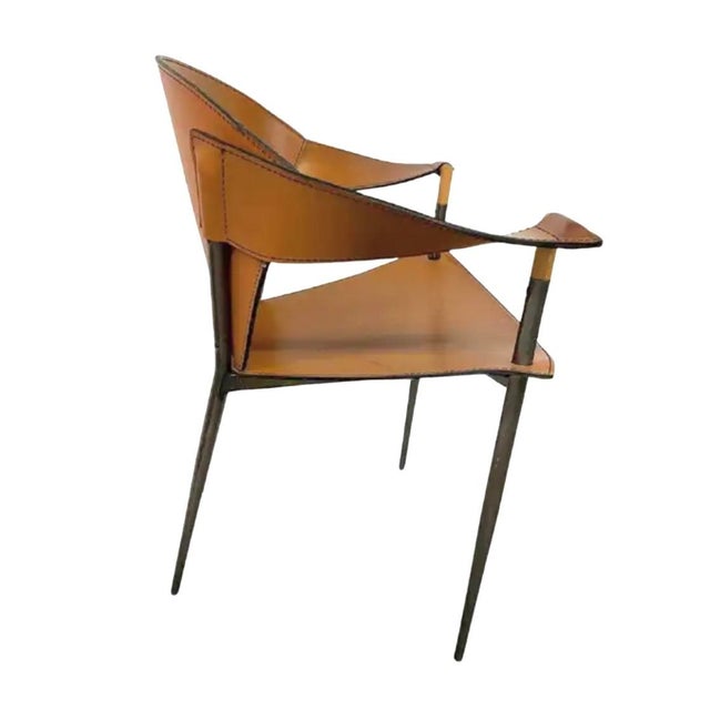 A pair Italian Arraben 'Jocauro' Chrome and Leather Armchairs. Each features a contoured leather seat and back that cradle...