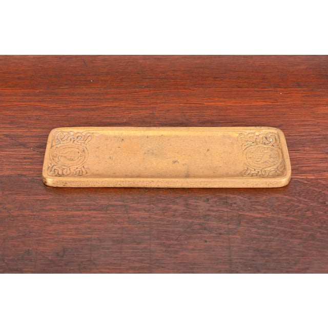 A gorgeous antique gilt bronze pen tray featuring Zodiac designs By Tiffany Studios (signed to the underside) New York,...