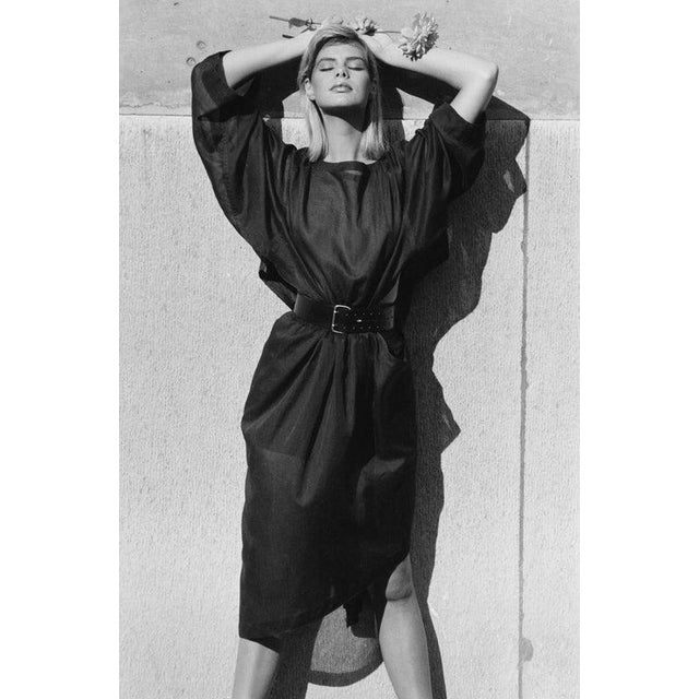 80s Fashion A model wearing a belted dress with an asymmetrical hemline, France, 17th October 1986. (Photo by M....