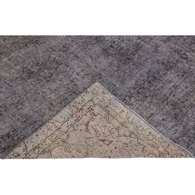 Beautiful Vintage Overdyed hand-knotted wool rug with a gray field. This Persian rug has black accents in an all-over...