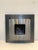 Sleek modern wall-mounted bio ethanol fireplace in brushed stainless steel with contrasting dark backing plate. The...