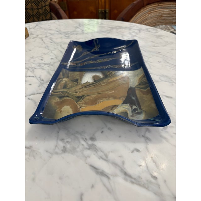 Rectangular blue fused glass tray or decorative dish featuring an abstract marbled brown and gold design one side and...