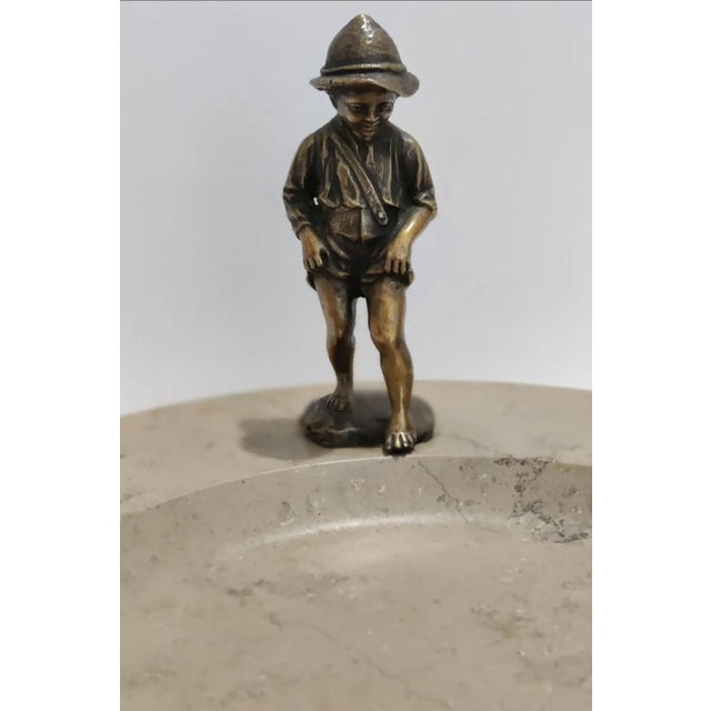 ABOUT Late 19th Century Signed Bronze figure of a boy dipping his toes to test a stream of water. The bronze sculpture is...