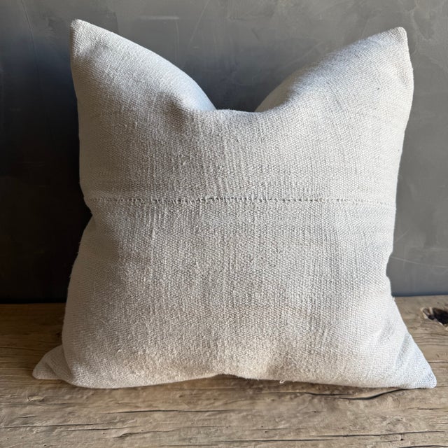 Creamy white hemp rug pillow with original seams. Soft hand, linen blend backing with zipper closure. Spot cleaning is...