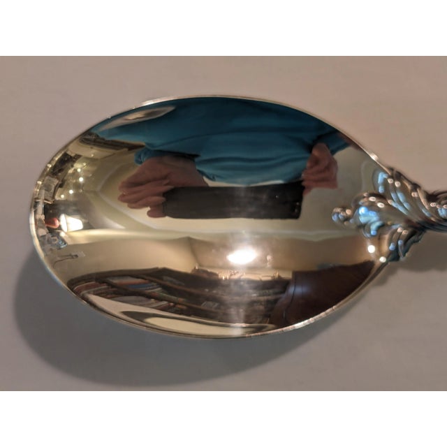 A sterling silver tablespoon in the highly desirable and unique "Romance of the Sea" pattern by Wallace. The wave and...