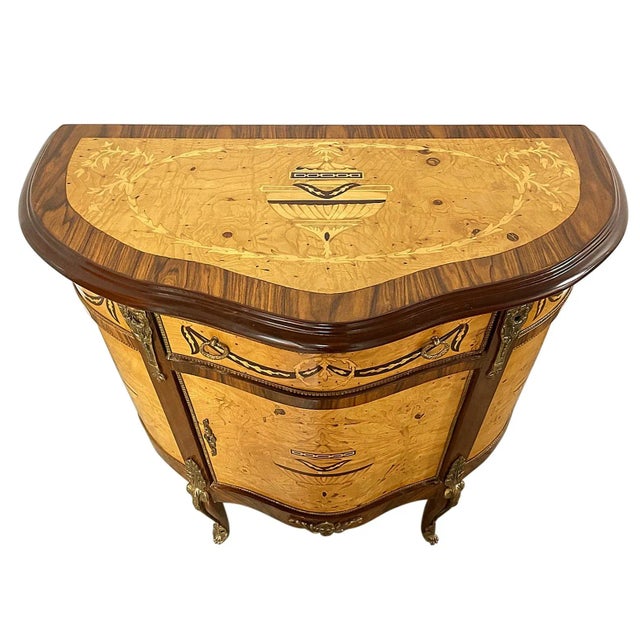 A French style cabinet with one drawer featuring exquisite inlay and brass hardware details. Refinished. Note that there...