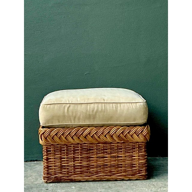 This vintage braided rattan ottoman embodies the relaxed elegance of mid-century design, celebrating the beauty of natural...