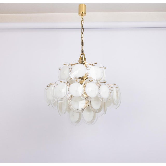 A stunning chandelier with murano hand-made disc glasses on a brass frame, italy, manufactured in, circa 1960-1969 very...