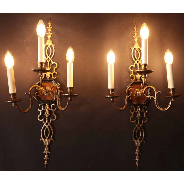 Heavy cast wall lights from a hunting lodge. Bronze body decorated with plant decor, fluted central part with blackened...