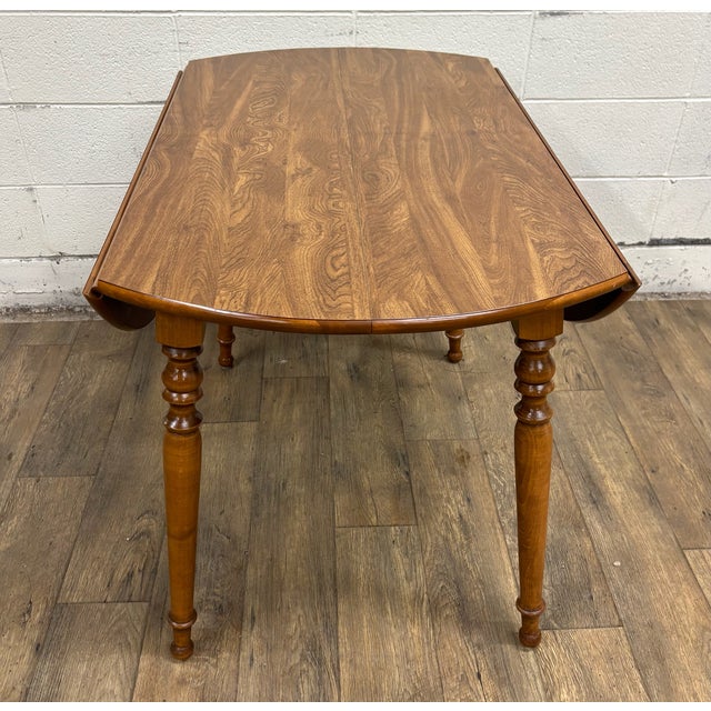 This is a gorgeous vintage Ethan Allen Heirloom Colonial style drop leaf dining table, 10-6103P. Solid, sturdy, and...