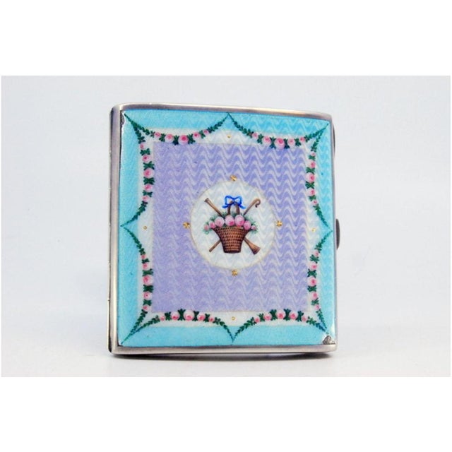 Enamelled Silver Cigarette Case with Flowers and Wavy Designs, in Very Good conditions. Designed from 2000 This piece has...