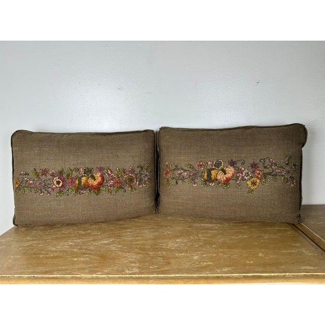 A pair of custom decorative pillows showcasing exquisite antique metallic and chenille embroidered appliqués, meticulously...