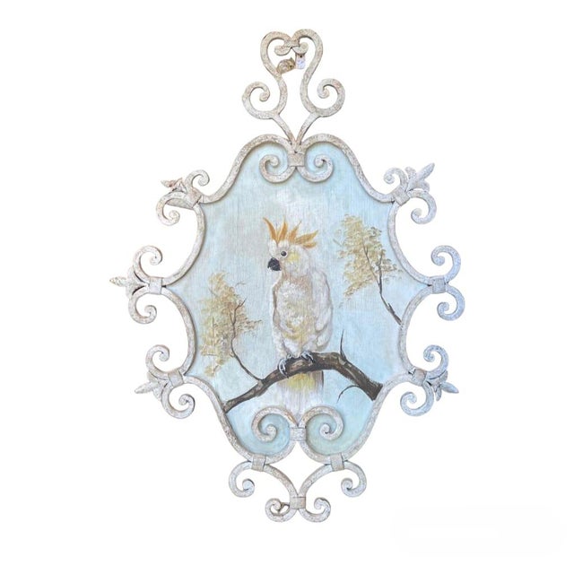 A pair of mid-20th-century oil paintings on panel depicting two white cockatoos. Both paintings are framed by an...