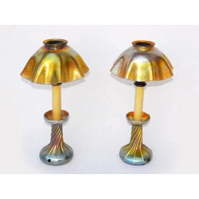 Antique American pair of art glass candlestick lamps signed LCT, Louis Comfort Tiffany, with gilt iridescent shade and...