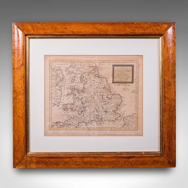 This is an antique map of England. A French, maple framed cartography engraving by Jean-Baptiste Nolin, this posthumous...
