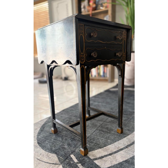 Elegant and distinctive, this antique mahogany leaf table server has been finished in a rich black lacquer paint in...