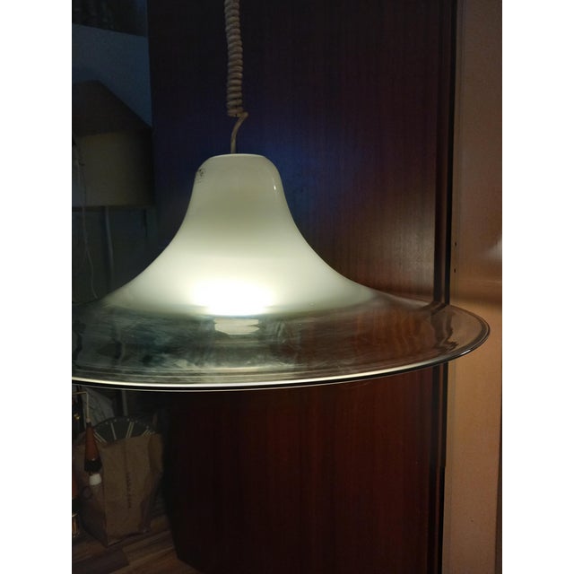 The pendant light is equipped with one E27 socket; it is shipped without a bulb. The glass lampshade is in excellent...