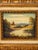 A charming vintage landscape painting depicting a serene riverside scene with rolling hills, lush greenery, and a distant...