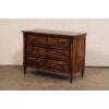 A French chest commode with really pretty veneer and dark trim, from the early 19th century. This antique chest from...