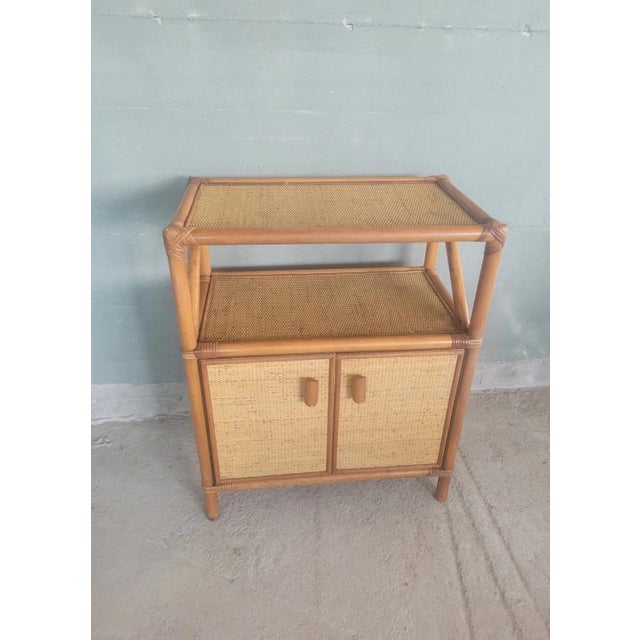 Vintage two-door rattan and bamboo sideboard. Excellent overall condition, with minor signs of wear. Dimensions Length: 66...