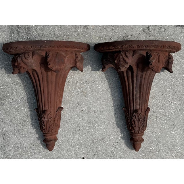 Vintage Neoclassical architectural wall corbels featuring carved acanthus detailing, fluted supports, and decorative...