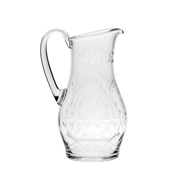 Graceful cut crystal pitcher, wish a beautiful pattern & rimmed with simple repeat pattern.