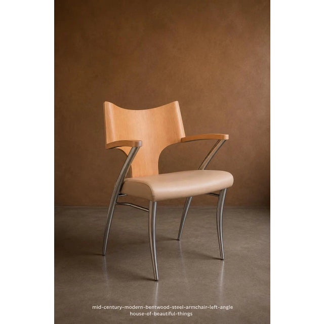 Sculptural mid-century modern style armchair combining a warm contoured bentwood backrest with a slender tubular steel...