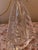 An elegant and distinctive decorative table lamp featuring a beautifully sculpted clear glass base with an unusual...