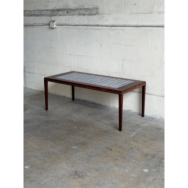 Beautiful Danish Modern coffee table manufactured by Vejle Møbelfabrik in Denmark during the 1960s. Crafted in richly...