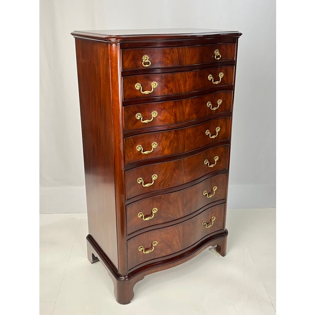 A rare flame mahogany serpentine tall chest of drawers by Henkel Harris. Crafted in Winchester, Virginia in 2003, this...