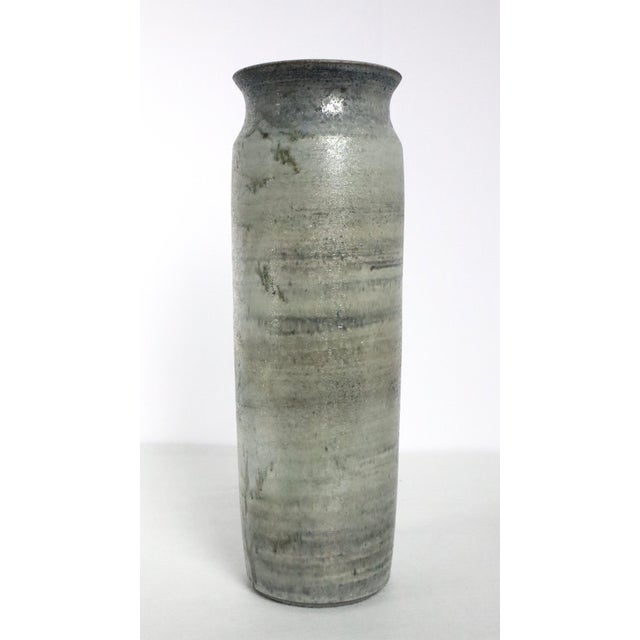 Tall tube vase in the style of Francine Delpierre, 1950. Made of stoneware with a powdery grey-blue finish. Decorated with...