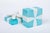 An authentic Tiffany & Co. porcelain trinket box shaped like the brand's iconic blue gift box. Features a square base with...