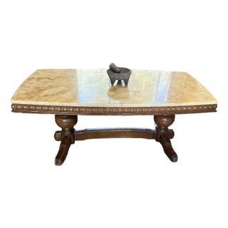 Wilhelminian-Style Coffee Table Features a Polished Honey-Toned Onyx or Marble Slab Top Resting on an Ornately Carved Double-Pedestal Wooden Base For Sale