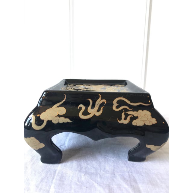 Striking chinoiserie black and gold ceramic stand with Dragon motif.