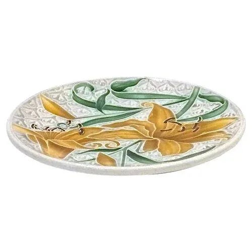 Antique English majolica plate incised with a small stylized lily design in the background and hand-painted with a large...