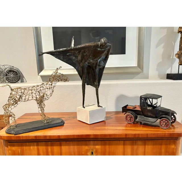 Artist Degen created this wire sculpture of a dog by hand and signed and dated it 2003 on the underside of the black...