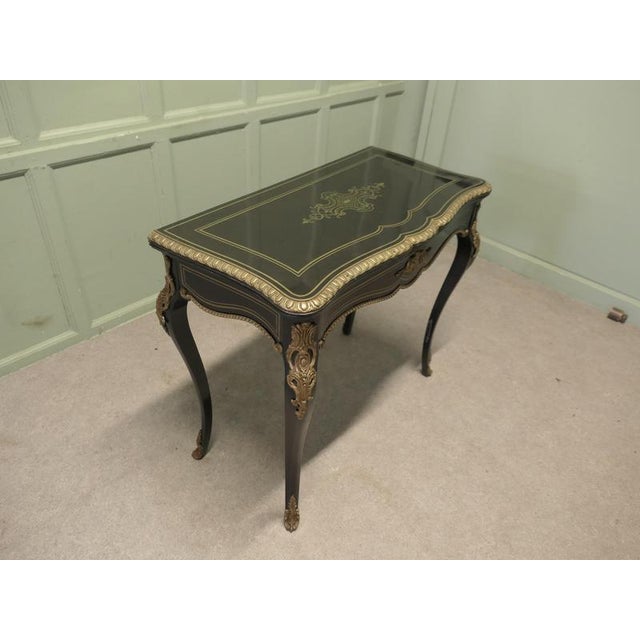 French Louis XV Style Ebonized Games Table with Brass Inlay. This is a very stylish French Table, it has a black ebonized...
