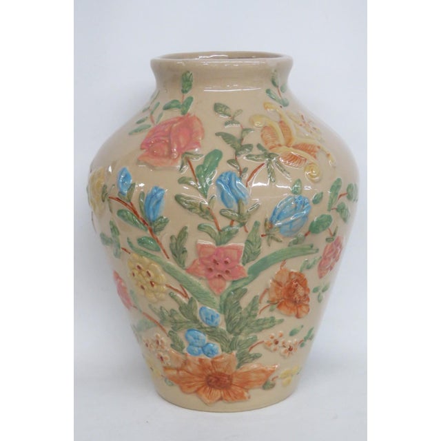 This gorgeous Large Jar Vase is made out of ceramic. Presenting a deep cream color base with raised floral motifs in pink,...