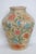 This gorgeous Large Jar Vase is made out of ceramic. Presenting a deep cream color base with raised floral motifs in pink,...